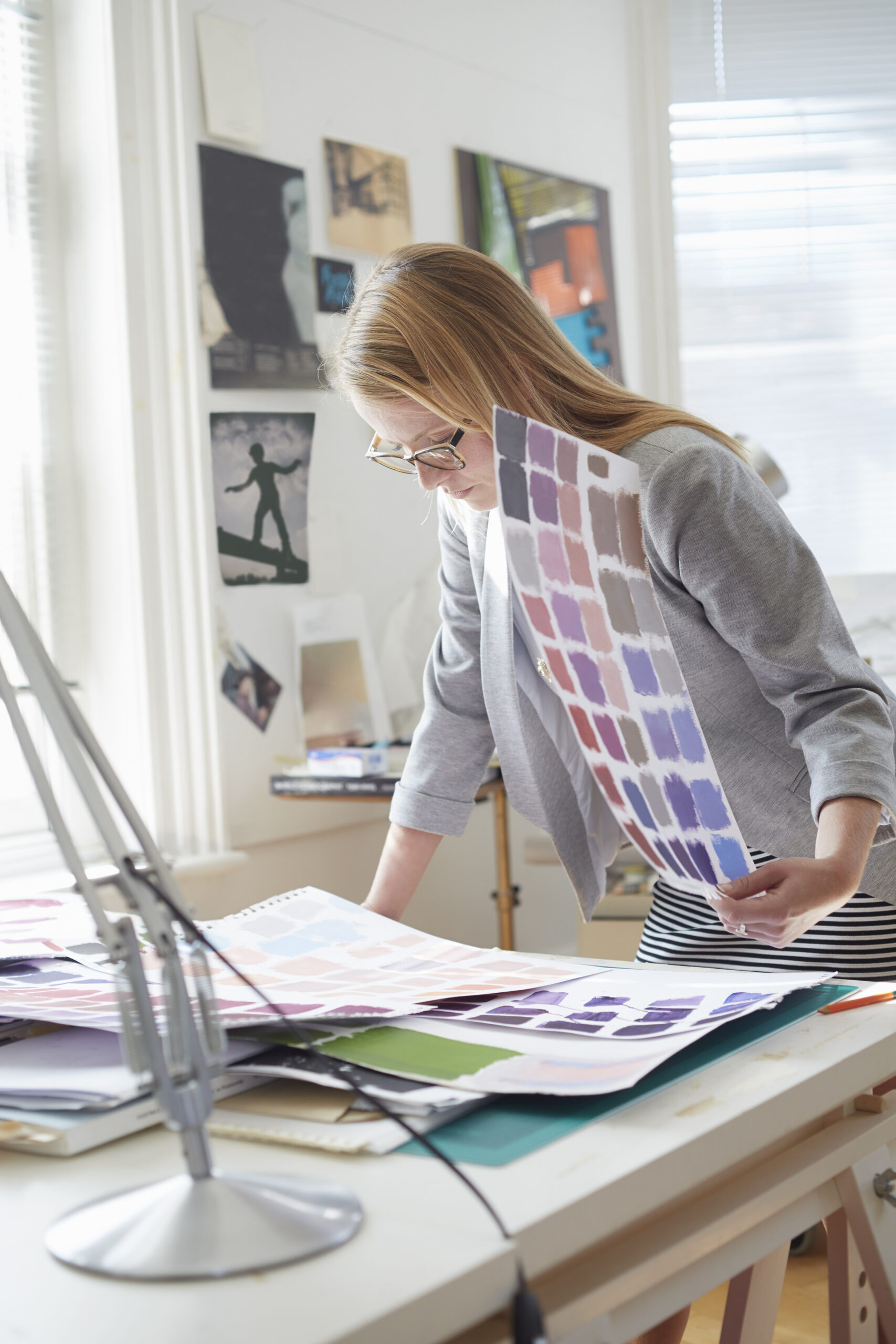 Designer studying color swatches in a bright studio Designer studying color swatches in a bright studio